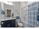 Bright bathroom featuring modern vanity, decorative stars, and blue striped shower curtain at 505 Marion Hills Way, Knightdale, NC 27545