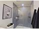 Stylish bathroom showcasing a glass-doored shower with gray tiling and unique wall art at 505 Marion Hills Way, Knightdale, NC 27545