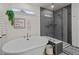 A freestanding soaking tub and glass enclosed shower stall feature stylish finishes at 505 Marion Hills Way, Knightdale, NC 27545
