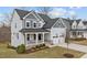 Charming two-story home with light blue siding, covered front porch, and two-car garage at 505 Marion Hills Way, Knightdale, NC 27545