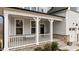 Inviting front porch with white railing, brick accents, and well-manicured landscaping at 505 Marion Hills Way, Knightdale, NC 27545