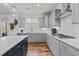Modern kitchen with gray cabinets, stainless appliances, and a large island with quartz countertops at 505 Marion Hills Way, Knightdale, NC 27545