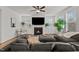 Comfortable living room with fireplace, large sectional, and ample natural light from the surrounding windows at 505 Marion Hills Way, Knightdale, NC 27545
