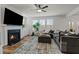Bright living room with fireplace, large sectional, and natural light coming in from the surrounding windows at 505 Marion Hills Way, Knightdale, NC 27545