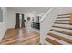 Open-concept living area with hardwood floors, stairs, and ample natural light at 505 Marion Hills Way, Knightdale, NC 27545
