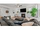 Living room featuring a cozy fireplace, large sectional sofa, and natural light from surrounding windows at 505 Marion Hills Way, Knightdale, NC 27545