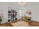 Home office with stylish decor, built-in shelving, and hardwood flooring at 505 Marion Hills Way, Knightdale, NC 27545