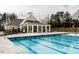 Community pool with an adjacent clubhouse and ample seating at 505 Marion Hills Way, Knightdale, NC 27545