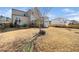A spacious backyard with grass, and a back view of the house at 518 Parlier Dr # 82, Apex, NC 27523