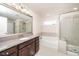 Main bathroom featuring granite countertop, brushed nickel faucet, soaking tub and glass shower at 518 Parlier Dr # 82, Apex, NC 27523