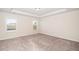 Spacious bedroom with neutral carpet, two windows, and a ceiling fan at 518 Parlier Dr # 82, Apex, NC 27523