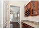 Convenient butler's pantry with granite countertops, cabinets, wine rack, and lighting at 518 Parlier Dr # 82, Apex, NC 27523