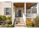 Inviting front porch with steps leading to the entrance and manicured landscaping at 518 Parlier Dr # 82, Apex, NC 27523