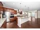 Modern kitchen with stainless steel appliances, granite countertops, and an expansive island at 518 Parlier Dr # 82, Apex, NC 27523