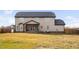 View of the home's backyard with a covered patio and expansive grassy area at 52 Reserve Dr, Fuquay Varina, NC 27526