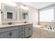 This bright bathroom features a double sink vanity and separate soaking tub at 52 Reserve Dr, Fuquay Varina, NC 27526