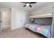 Neutral-toned bedroom features carpet, bunk beds, closet, and ceiling fan at 52 Reserve Dr, Fuquay Varina, NC 27526