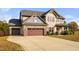 Two-story home with a three-car garage and well-manicured landscaping at 52 Reserve Dr, Fuquay Varina, NC 27526
