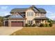 Charming two-story home featuring a combination of stone and siding accents, complemented by a well-manicured lawn at 52 Reserve Dr, Fuquay Varina, NC 27526