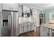 Well-equipped kitchen with stainless steel refrigerator and appliances, grey cabinets, and hardwood floors at 52 Reserve Dr, Fuquay Varina, NC 27526