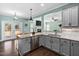 Modern kitchen with stainless steel appliances, granite countertops, and an open view into the living room at 52 Reserve Dr, Fuquay Varina, NC 27526