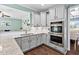 Spacious kitchen featuring stainless appliances, granite countertops, grey cabinetry, and hardwood flooring at 52 Reserve Dr, Fuquay Varina, NC 27526