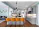 Open-concept kitchen with granite countertops, stainless steel appliances, bar seating, and hardwood floors at 52 Reserve Dr, Fuquay Varina, NC 27526