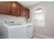 Bright laundry room with overhead cabinets and modern appliances at 52 Reserve Dr, Fuquay Varina, NC 27526