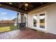 Covered patio with brick flooring, ceiling fan, string lights, and outdoor grill at 52 Reserve Dr, Fuquay Varina, NC 27526