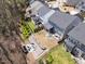 Beautiful aerial shot of a home's backyard featuring a fire pit and landscaped grounds, nestled among trees at 521 Ivy Arbor Way, Holly Springs, NC 27540