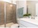 Bathroom featuring a tiled walk-in shower, white vanity, and modern fixtures at 521 Ivy Arbor Way, Holly Springs, NC 27540