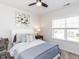 Inviting bedroom with a white bed, floral artwork, and a window letting in sunlight at 521 Ivy Arbor Way, Holly Springs, NC 27540