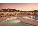 Stunning community pool with ample lounge chairs and elegant sunset ambiance, perfect for relaxation and recreation at 521 Ivy Arbor Way, Holly Springs, NC 27540