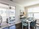 Charming dining area leading to a screened porch, with views of the outdoor living space and manicured yard at 521 Ivy Arbor Way, Holly Springs, NC 27540