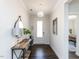 Bright entryway featuring a modern light fixture, wood floors, and views into the office space at 521 Ivy Arbor Way, Holly Springs, NC 27540