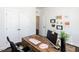 Cozy office with a large desk, closet, and decorative art creates a functional yet inviting workspace at 521 Ivy Arbor Way, Holly Springs, NC 27540