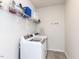 Well-organized laundry room featuring modern washer and dryer units with wire shelving at 521 Ivy Arbor Way, Holly Springs, NC 27540