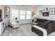 Cozy living room with neutral tones, comfortable seating, and ample natural light from large windows at 521 Ivy Arbor Way, Holly Springs, NC 27540