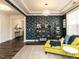 Living room featuring dark wood floors, blue accent wall, and decorative furniture at 521 Ivy Arbor Way, Holly Springs, NC 27540
