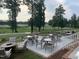 Inviting outdoor seating area overlooking a lush golf course, perfect for enjoying scenic views and dining at 521 Ivy Arbor Way, Holly Springs, NC 27540