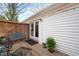 Charming back porch with a seating area and sliding glass doors to the house at 528 Moseley Ln, Raleigh, NC 27601