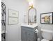 Cozy bathroom with a decorative mirror, vanity, and artwork at 528 Moseley Ln, Raleigh, NC 27601