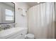 Clean bathroom with a modern vanity, toilet, and shower with a white curtain at 528 Moseley Ln, Raleigh, NC 27601