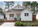 Charming home featuring a covered front porch, brick accents, and a well-manicured lawn at 528 Moseley Ln, Raleigh, NC 27601