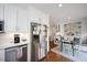 Bright kitchen boasts stainless steel appliances, white cabinetry and an adjacent breakfast nook at 528 Moseley Ln, Raleigh, NC 27601