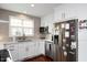 Well-lit kitchen featuring white cabinets, stainless steel appliances, and a stylish backsplash at 528 Moseley Ln, Raleigh, NC 27601