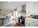 Open kitchen featuring stainless steel appliances, white cabinets, and a view to the breakfast nook at 528 Moseley Ln, Raleigh, NC 27601