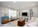 Bright living area with large windows, built-in shelves, and hardwood flooring at 528 Moseley Ln, Raleigh, NC 27601