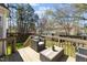 Relaxing back deck features outdoor seating, a green backyard, and a wooden fence at 5313 Wenesly Ct, Raleigh, NC 27616