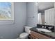 Bright bathroom with granite countertop, white toilet, and a view to the backyard at 5313 Wenesly Ct, Raleigh, NC 27616